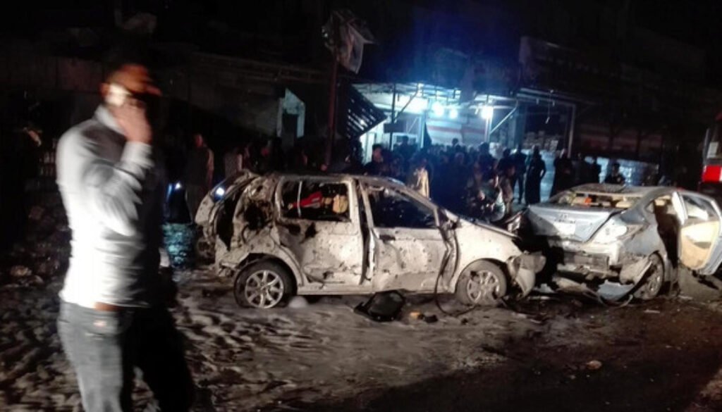 Destroyed cars are seen at the site of a car bomb attack in the Amil neighborhood in Baghdad