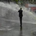 Senior Advocate Supreme Court Mr. Sharafat Khan facing water canon at Front Line.